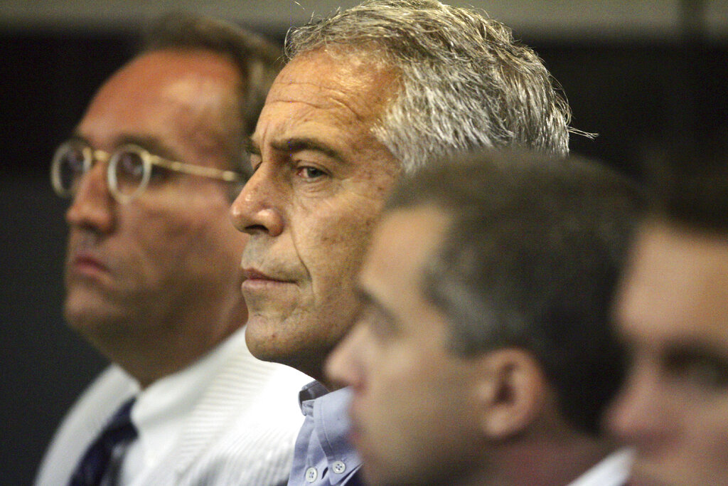 Jeffrey Epstein, center, appears in court in West Palm Beach