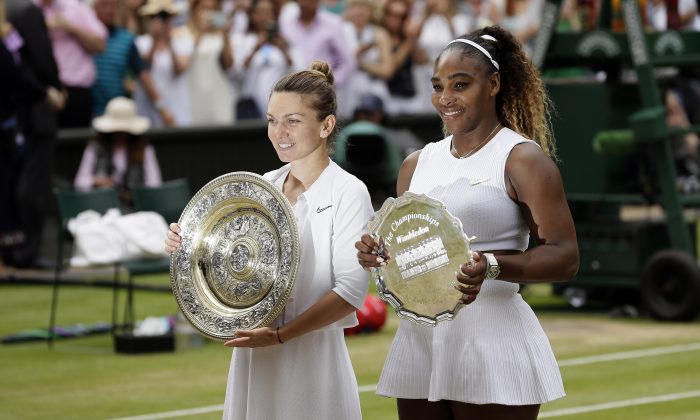 Winner Romania's Simona Halep and second placed United States' Serena Williams (R) pose with their trophies after the women's singles final match on day twelve of the Wimbledon Tennis Championships in London, on July 13, 2019. (Tim Ireland/AP Photo)