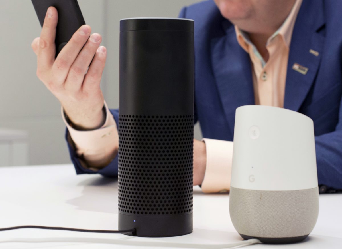 An Amazon Echo, center, and a Google Home, right, are displayed