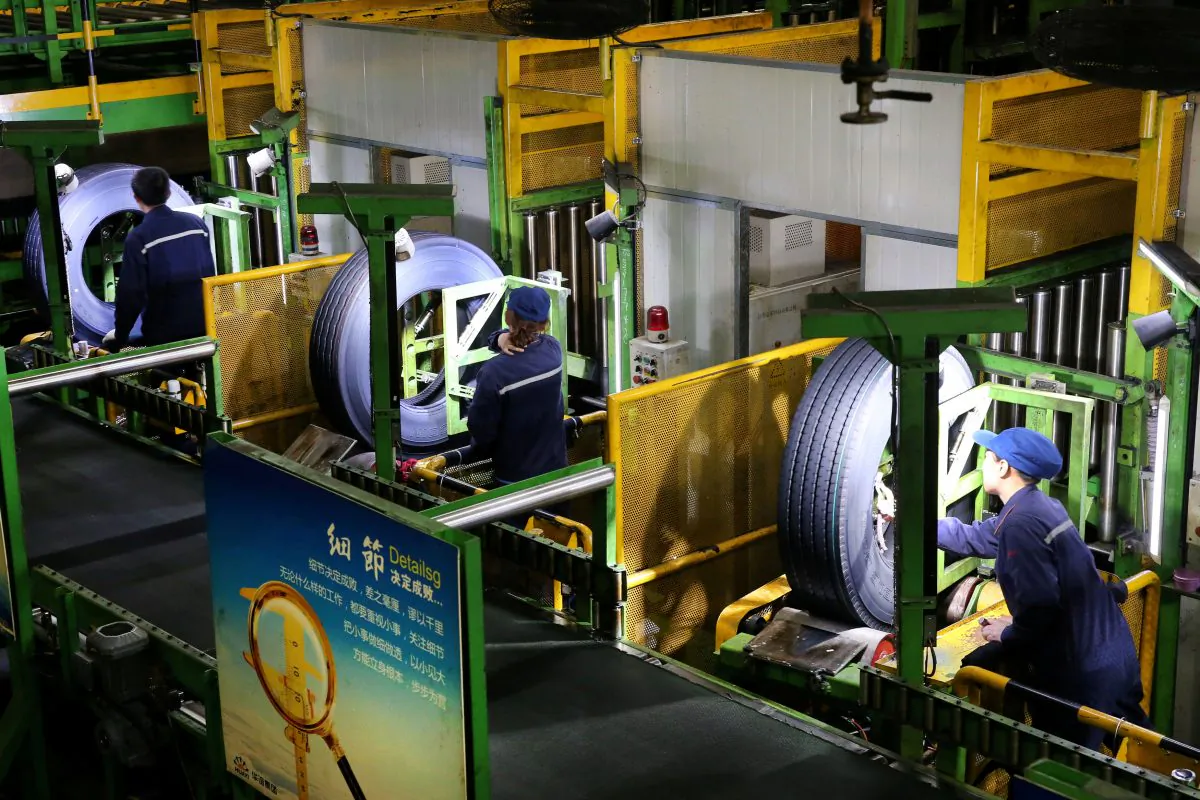 Workers are seen at a production line manufacturing tires at a factory in Nantong, Jiangsu Province, China on April 28, 2019. (Reuters)