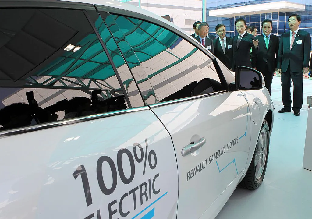 Former South Korean President Lee Myung-Bak (C) looks at an electric car during a dedication ceremony for LG Chem's car battery plant at the town of Ochang, South Korea, on April 6, 2011. (Dong-A Ilbo/AFP/Getty Images)