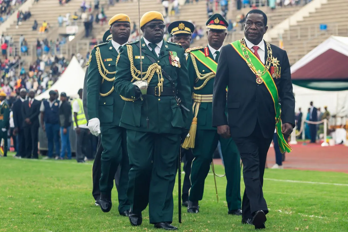 Zimbabwe's President Emmerson Mnangagwa (R) at the country's National Sports Stadium on April 18, 2019. JEKESAI NJIKIZANA/AFP/Getty Images