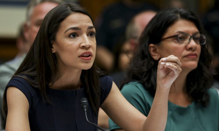 Reps Alexandria Ocasio-Cortez (L) and Rashida Tlaib at a House hearing in front of the Committee on Oversight and Reform, in Washington on July 12, 2019. (Charlotte Cuthbertson/The Epoch Times)