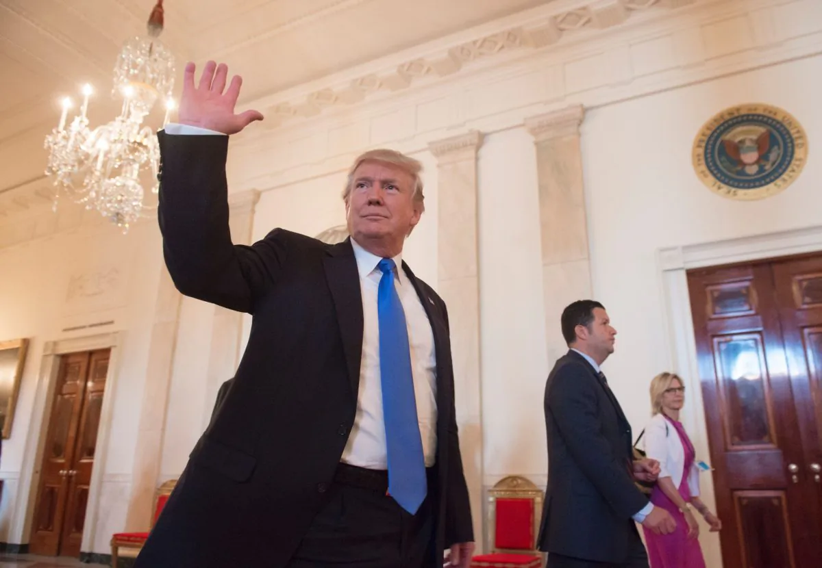 U.S. President Donald Trump walks down the Cross Hall following a Made in America event with U.S. manufacturers in the East Room of the White House in Washington on July 19, 2017. (Saul Loeb/AFP/Getty Images)