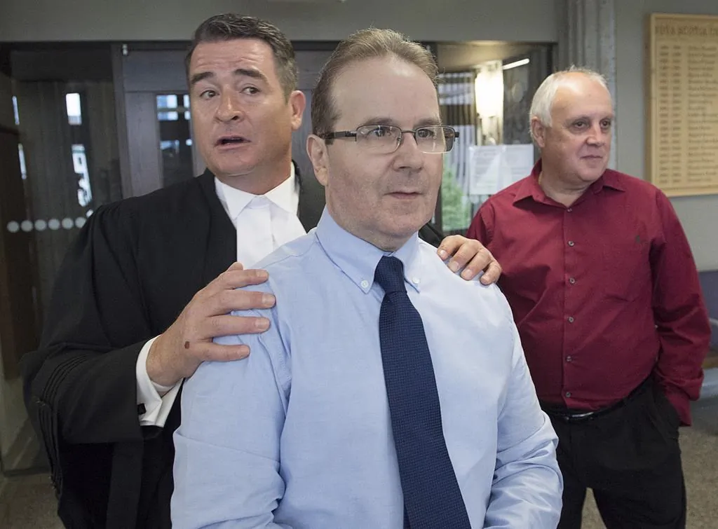 Glen Assoun, the Nova Scotia man who spent almost 17 years in prison for a crime he didn't commit, his lawyer Sean MacDonald and Ron Dalton, right, from the advocacy group Innocence Canada, stand outside Supreme Court in Halifax on July 12, 2019. (Andrew Vaughan/The Canadian Press)