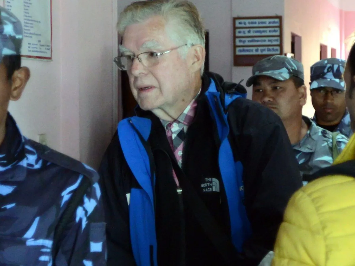 Canadian Ernest MacIntosh is escorted by police to his court appearance in Lalitpur, Nepal, on Feb. 5, 2015, on charges of allegedly abusing a 9-year-old boy in a suburb of Kathmandu. (PRAKASH MATHEMA/AFP/Getty Images)