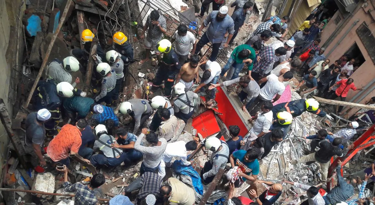Rescue workers and residents search for survivors at the site of a collapsed building in Mumbai, India on July 16, 2019. (Stringer/Reuters)