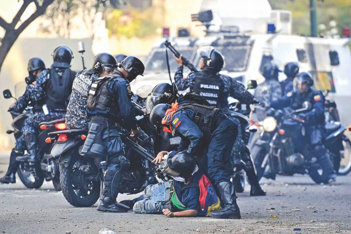 An anti-Maduro protester is detained by security forces during clashes in Caracas on May 1, 2019.  (
FEDERICO PARRA/AFP/Getty Images)