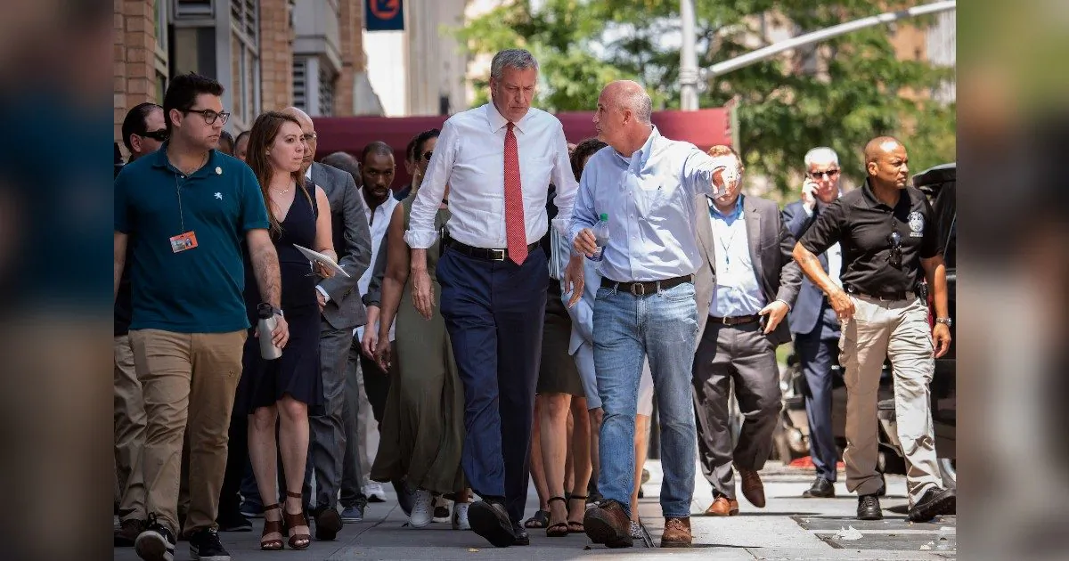 New York Mayor Bill de Blasio, center left, listens to Con Ed President Tim Cawley, July 14, 2019, as the mayor visits the site of the power outage on July 13, on New York's Upper West Side. (Michael Appleton/Mayoral Photography Office via AP)