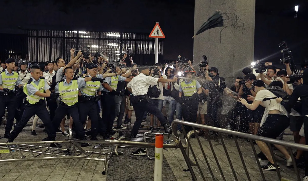 Police officers use pepper spray against protesters in a rally against the proposed amendments to the extradition law at the Legislative Council in Hong Kong, China on June 10, 2019. (Vincent Yu/AP)