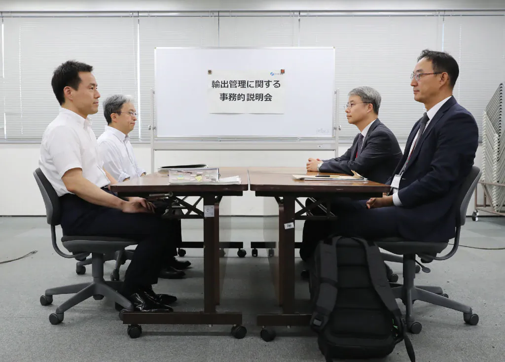 Jun Iwamatsu (front L), a director of trade control policy division at Japan's Ministry of Economy, Trade and Industry (METI) holds a meeting with his South Korean officers (R) on the imposed restrictions, in Tokyo on July 12, 2019. (Jiji Press/AFP/Getty Images))