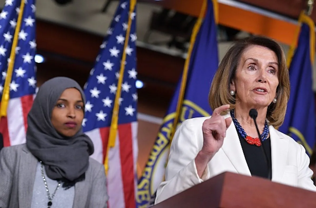House Minority Leader Nancy Pelosi speaks during a press conference in the House Visitors Center at the US Capitol in Washington, DC on Nov. 30, 2018. At left is representative-elect Ilhan Omar, D-MN. (MANDEL NGAN / AFP)