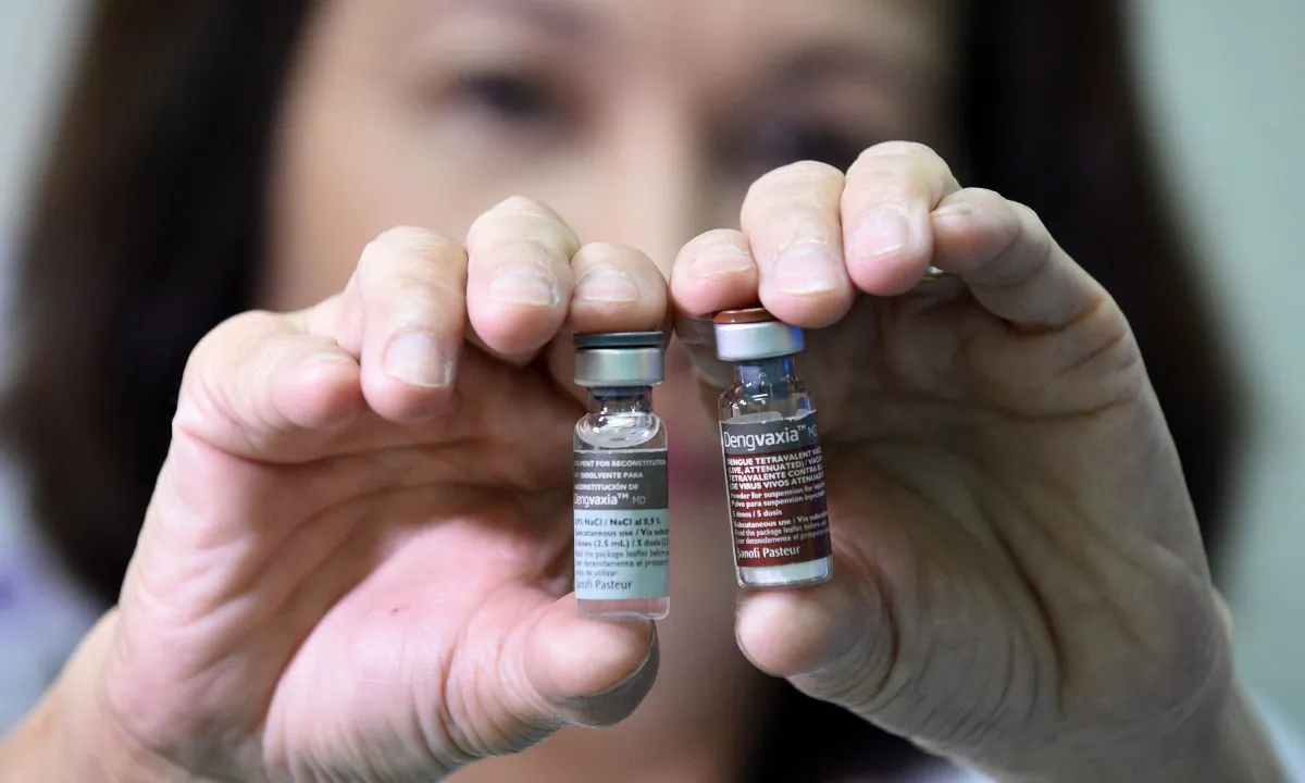 A woman holding up medical vials. (Ted Aljibe/AFP/Getty Images)