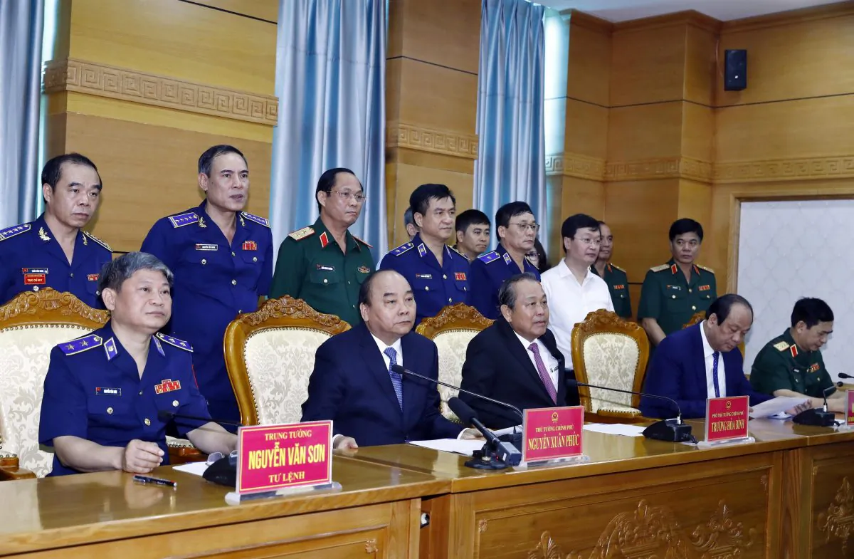 Vietnam's Prime Minister Nguyen Xuan Phuc (2nd L, front) and Deputy Prime Minister Truong Hoa Binh (2nd R, front) speaks with sailors of Coast Guard Force on field via video call during their visit to Coast Guard Command in Hanoi, Vietnam on July 11, 2019. (Thong Nhat/VNA via Reuters)