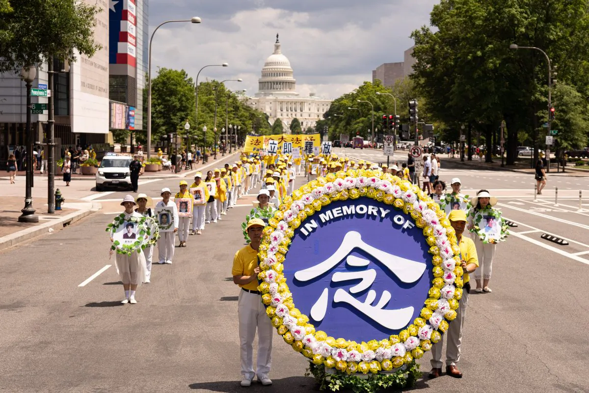 Falun Gong practitioners march from the U.S. Capitol to the Washington Monument to commemorate the 20th anniversary of Chinse regime's persecution of the practice on July 18, 2019. (Larry Dye/The Epoch Times)