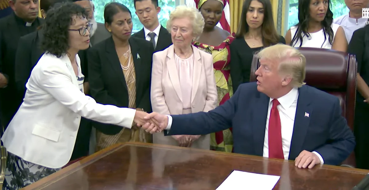 President Donald Trump shakes hands with Zhang Yuhua, a Falun Gong practitioner who survived persecution in China, at the White House on July 17, 2019. (Screenshot/The White House)