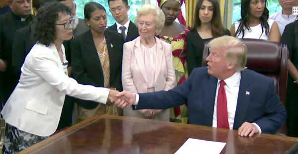 Yuhua Zhang shakes hands with president donald trump