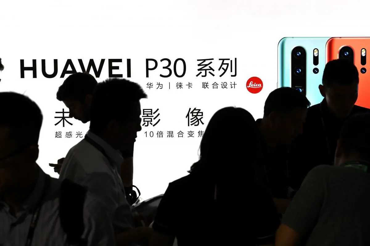 People visit a Huawei stand at the Shanghai New International Expo Centre in Shanghai on June 26, 2019. (Hector Retamal/AFP/Getty Images)