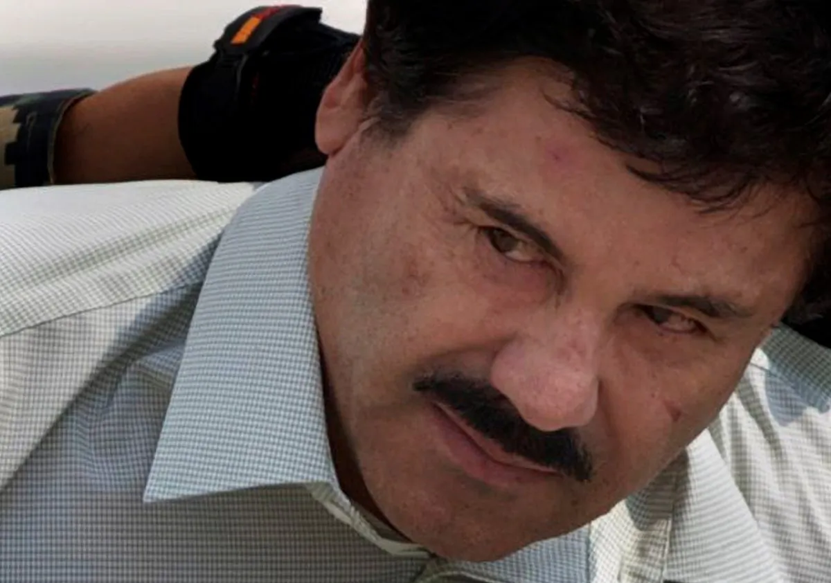 Joaquin "El Chapo" Guzman is escorted to a helicopter in handcuffs by Mexican navy marines at a navy hanger in Mexico City on Feb. 22, 2014. (Eduardo Verdugo/AP Photo)