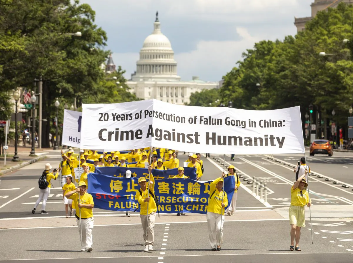 Falun Gong practitioners march from the U.S. Capitol to the Washington Monument commemorating the 20th anniversary of the persecution of Falun Gong in China, in Washington D.C., on July 18, 2019. (Samira Bouaou/The Epoch Times)