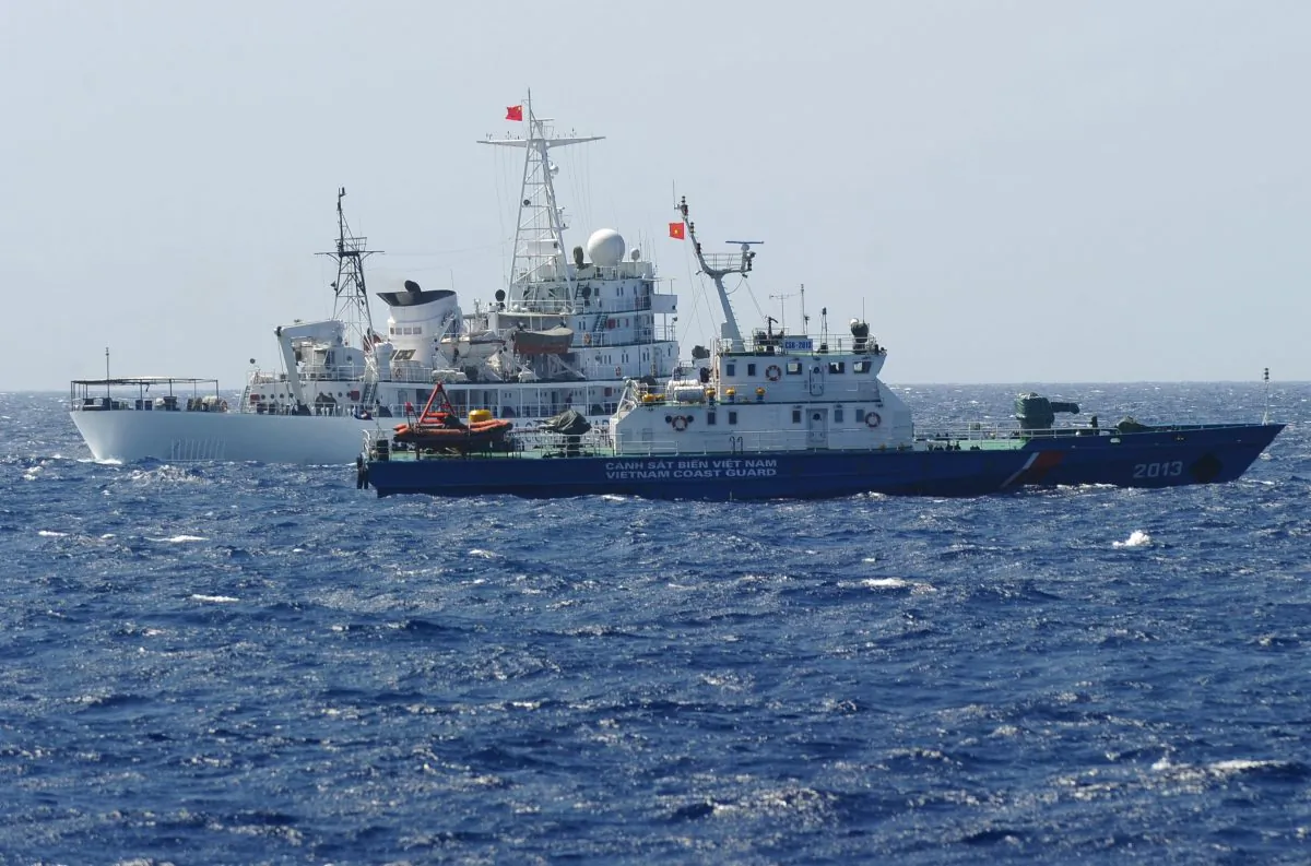 A Chinese coast guard ship (back) sailing next to a Vietnamese coast guard vessel (front), near China's oil drilling rig in disputed waters in the South China Sea, on May 14, 2014. (Hoang Dinh Nam/AFP/Getty Images)