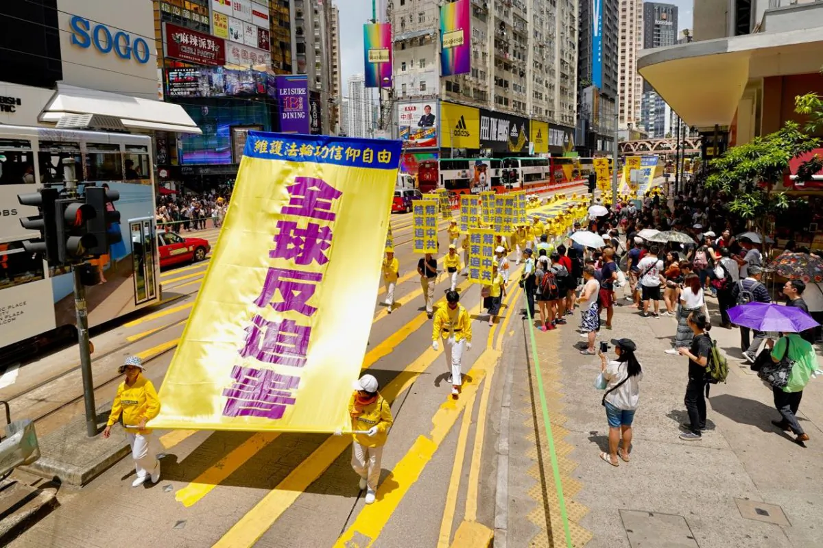 Falun Gong practitioners hold up a banner with the words “Global Opposition to Persecution” in a march in Hong Kong on July 21, 2019. (Li Yi/The Epoch Times)