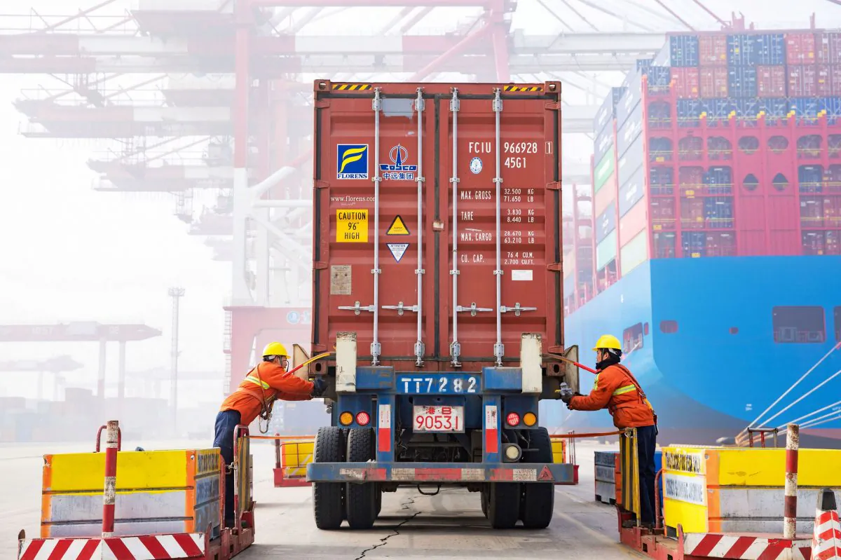 Workers prepare a container at the port in Qingdao, China's eastern Shandong province, on Jan. 14, 2019. (STR/AFP/Getty Images)