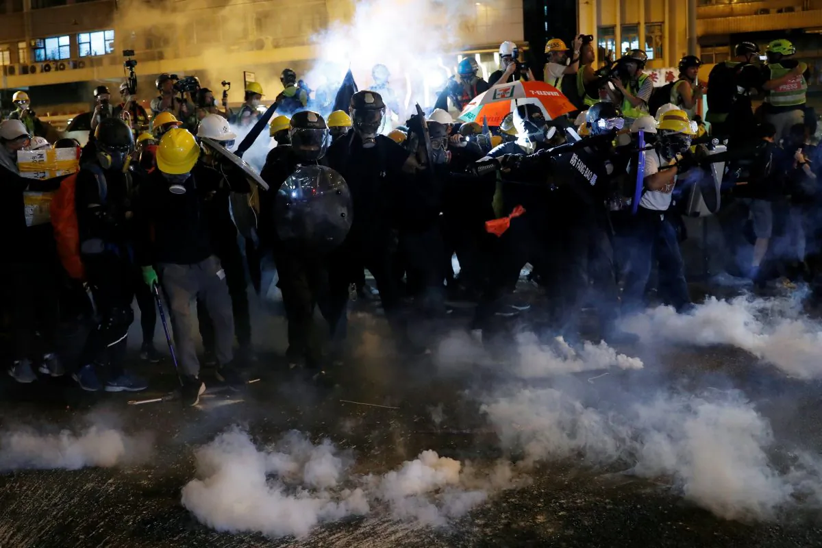 Anti-extradition bill demonstrators react as riot police fire tear gas after a march to call for democratic reforms, in Hong Kong, China on July 21, 2019. (Tyrone Siu/Reuters)
