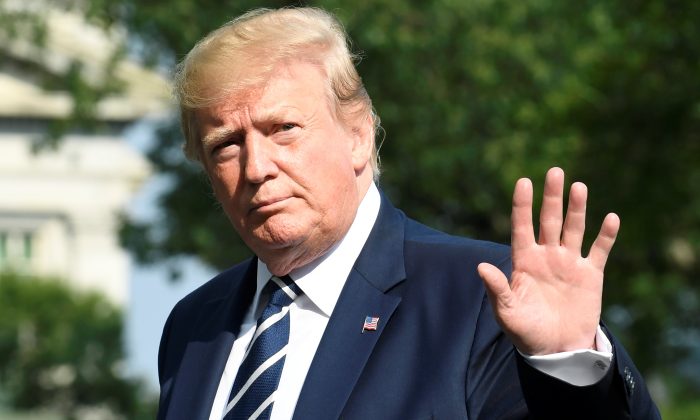 President Donald Trump waves to the press as he returns to the White House, Washington, D.C., after a weekend at his golf club in Bedminster, New Jersey on July 21, 2019. (Mike Theiler/Reuters)