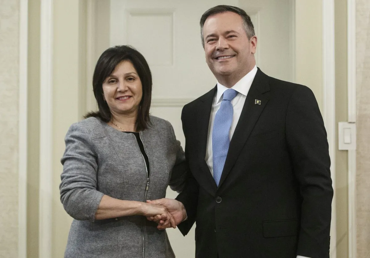 Alberta Premier Jason Kenney shakes hands with Education Minister Adriana LaGrange after she was sworn into office in Edmonton on April 30, 2019. (The Canadian Press/Jason Franson)