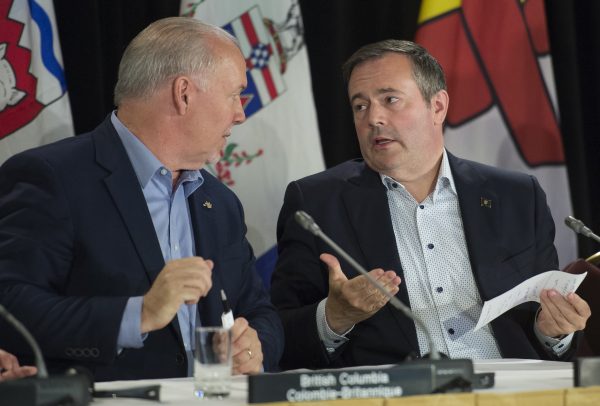 British Columbia Premier John Horgan speaks with Alberta Premier Jason Kenney following a closing news conference at a meeting of Canada's Premiers in Saskatoon, Sask., July 11, 2019.(Jonathan Hayward/The Canadian Press)