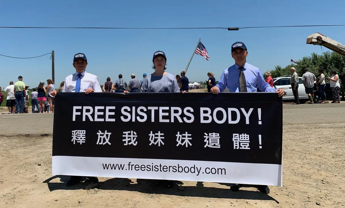 Falun Gong practitioners holding a banner at the USMCA event on July 10, 2019. (Cynthia Cai/Epoch Times)