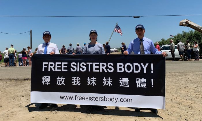 Falun Gong practitioners holding a banner at the USMCA event on July 10, 2019. (Cynthia Cai/Epoch Times)