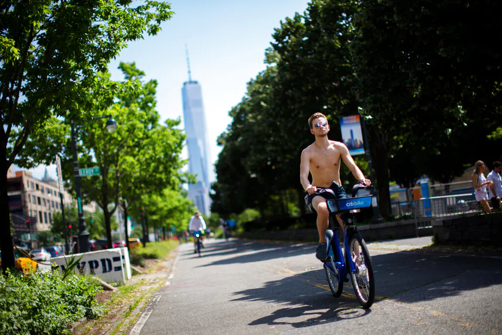 Cyclists ride down a path near the Hudson River during high temperatures, New York, on July 20, 2019. (Eduardo Munoz Alvarez/AP Photo)