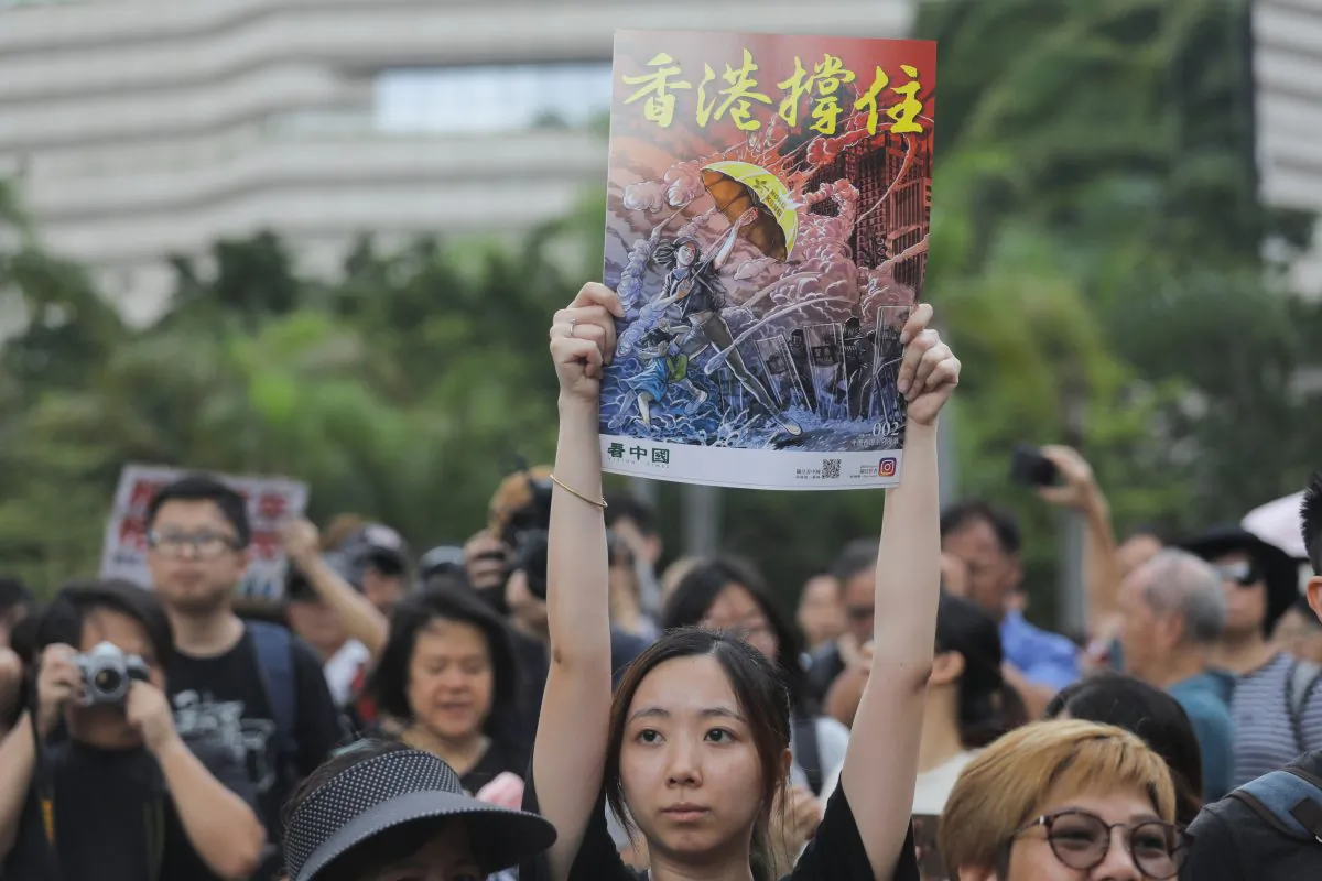 Protesters gather before a march to the West Kowloon railway station holding posters made by Canadian artist Daxiong Guo, during a demonstration against a proposed extradition bill in Hong Kong on July 7, 2019. (Vivek Prakash/AFP/Getty Images)