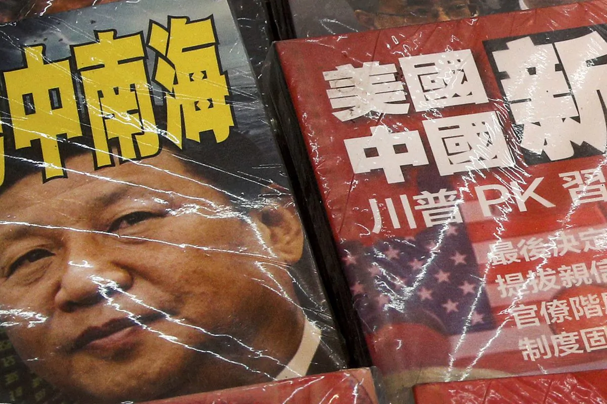 In this Thursday, July 4, 2019, photo, magazines with a front cover featuring Chinese leader Xi Jinping with South China Sea and Xi against U.S. President Donald Trump is placed on sale at a roadside bookstand in Hong Kong. The United States said it's concerned by reports of China's interference with oil and gas activities in the disputed waters of the South China Sea, where Vietnam accuses Beijing of violating its sovereignty. (Andy Wong/AP)