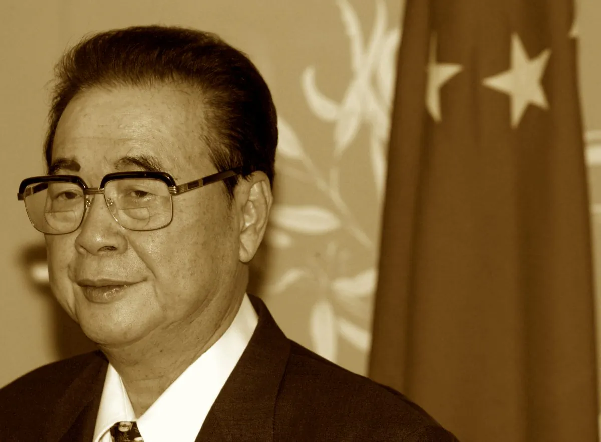 Chairman of the National Congress of the People's Republic of China Li Peng stands next to a Chinese flag in Canberra's Parliament House in Australia on Sept. 16, 2002. (David Gray/Reuters)