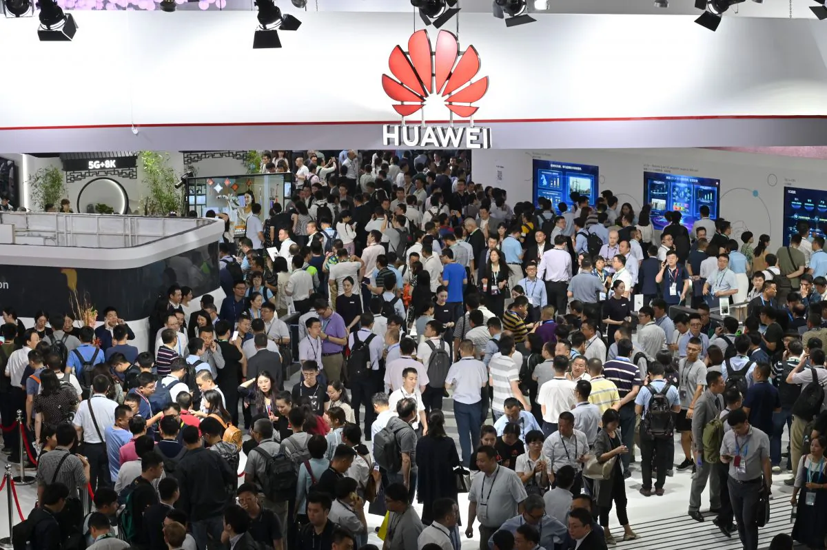People visit a Huawei stand during the Mobile World Congress at the Shanghai New International Expo Centre in Shanghai on June 26, 2019. (HECTOR RETAMAL/AFP/Getty Images)