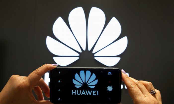A Huawei logo is seen on a cell phone screen in their store at Vina del Mar, Chile  on July 18, 2019. (Rodrigo Garrido/Reuters)