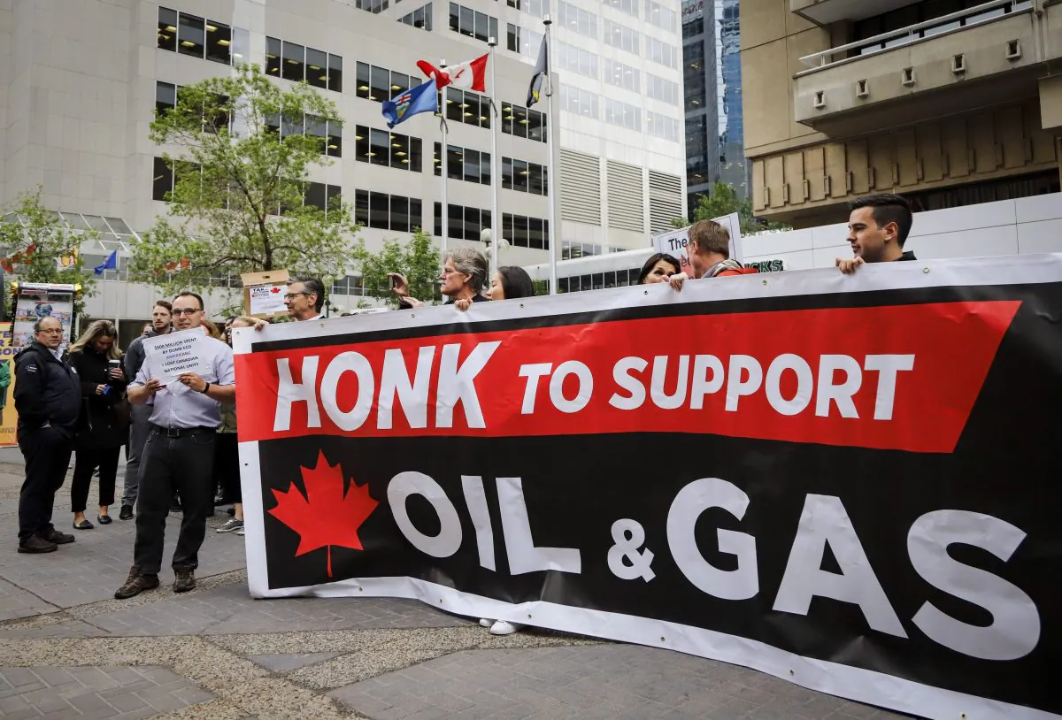Oil and gas industry supporters rallied outside the venue where Finance Minister Bill Morneau spoke in Calgary on June 19, 2019. Strong political will is needed at all levels of government to curtail regulations that thwart the growth of the oil and gas sector. (The Canadian Press/Jeff McIntosh)