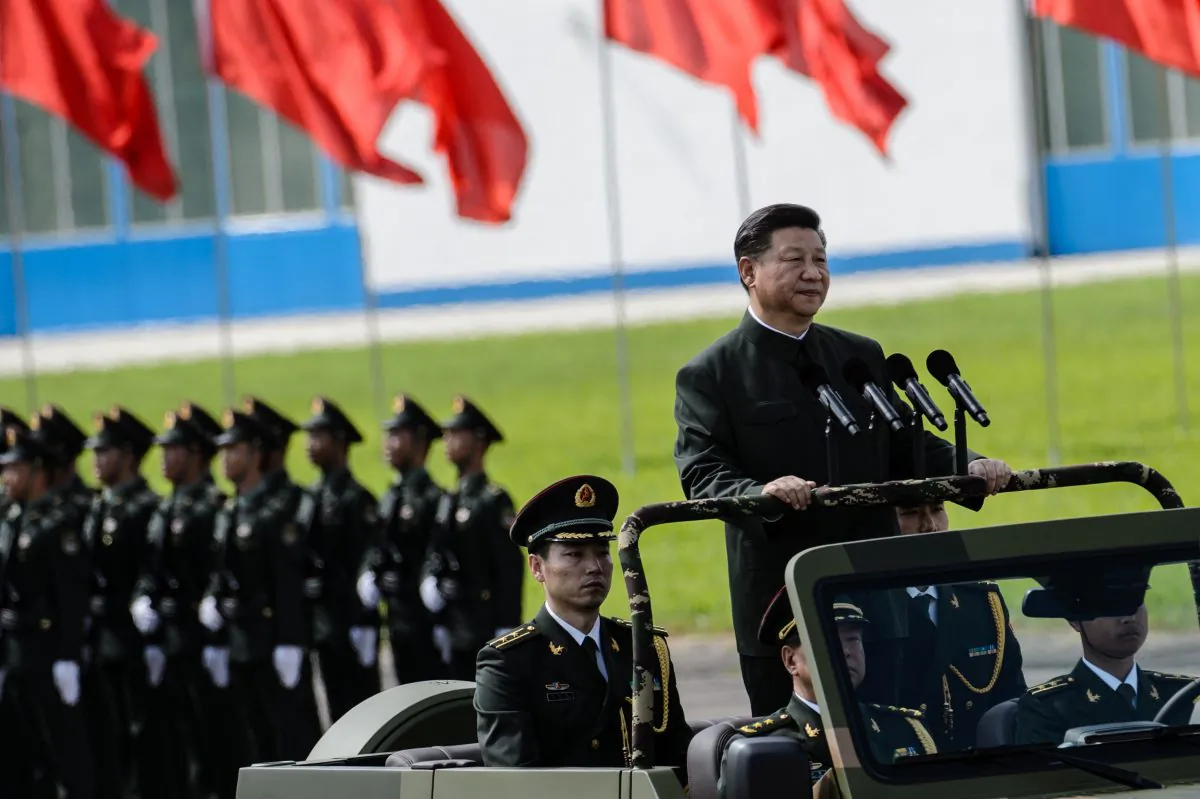 Chinese leader Xi Jinping (R) reviews troops from a car at a garrison of the People's Liberation Army in Hong Kong on June 30, 2017. (ANTHONY WALLACE/AFP/Getty Images)