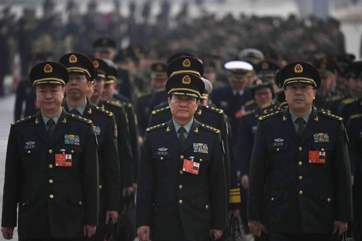 Chinese military delegates arrive for the sixth plenary session of the National People's Congress (NPC) at the Great Hall of the People in Beijing on March 18, 2018. (Greg Baker/AFP/Getty Images)