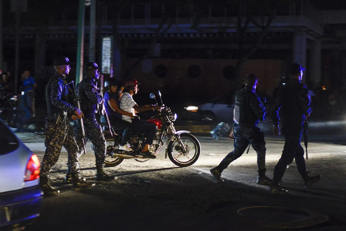 Soldiers and passersby walk in the Petare neighbourhood after Caracas and other parts of Venezuela were hit by a massive power cut on July 22, 2019. (Matias Delacroix/AFP/Getty Images)