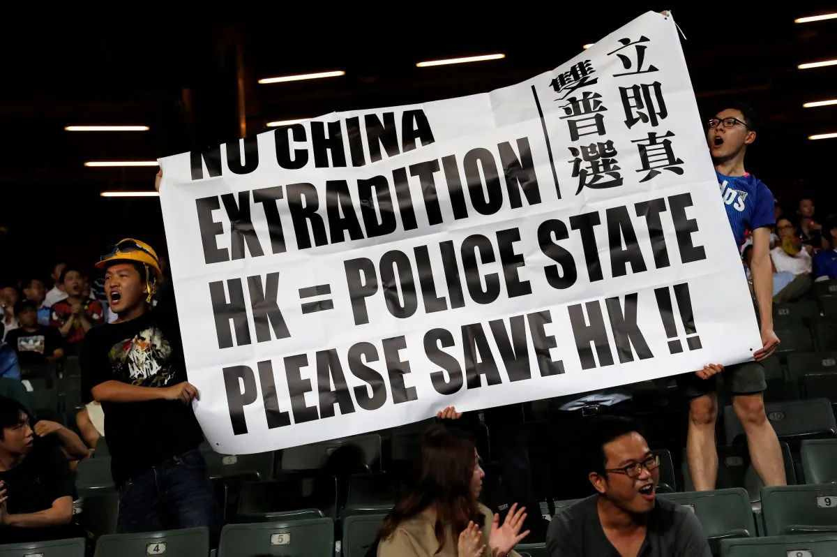 Fans hold an anti-extradition bill banner during a friendly match between Manchester City Football Club and Kitchee, in Hong Kong, China on July 24, 2019. (Tyrone Siu/Reuters)