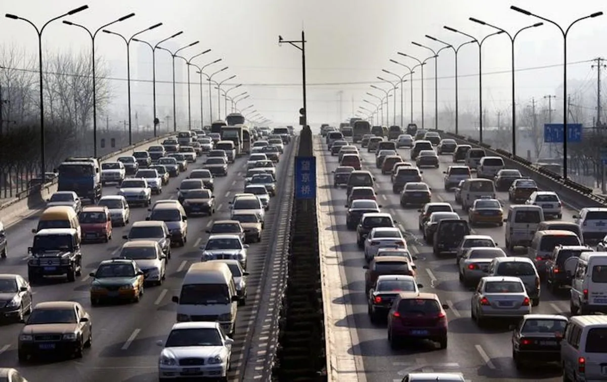 Cars drive along a main road in central Beijing on Jan. 12, 2012. (David Gray/Reuters)