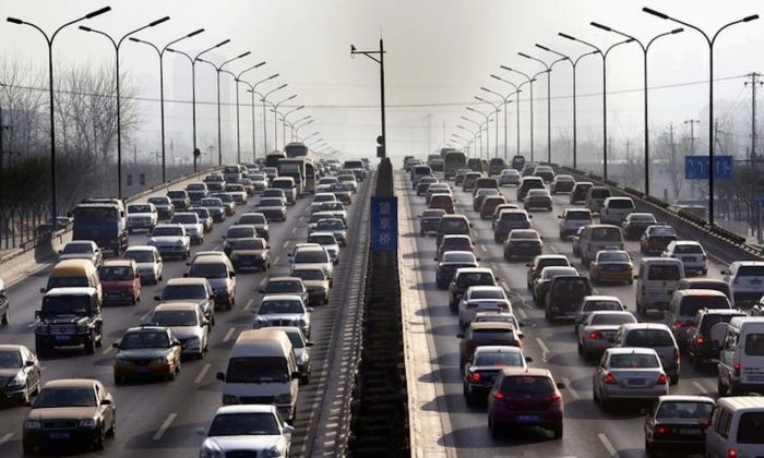 Cars drive along a main road in central Beijing on Jan. 12, 2012. (David Gray/Reuters)
