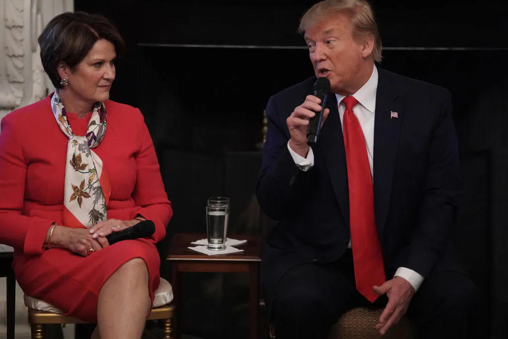 President Donald Trump speaks as Chairman, President and CEO of Lockheed Martin Marillyn Hewson looks on during a State Dining Room event to mark the one year anniversary of the “Pledge to America’s Workers” at the White House in Washington, on July 25, 2019. (Alex Wong/Getty Images)