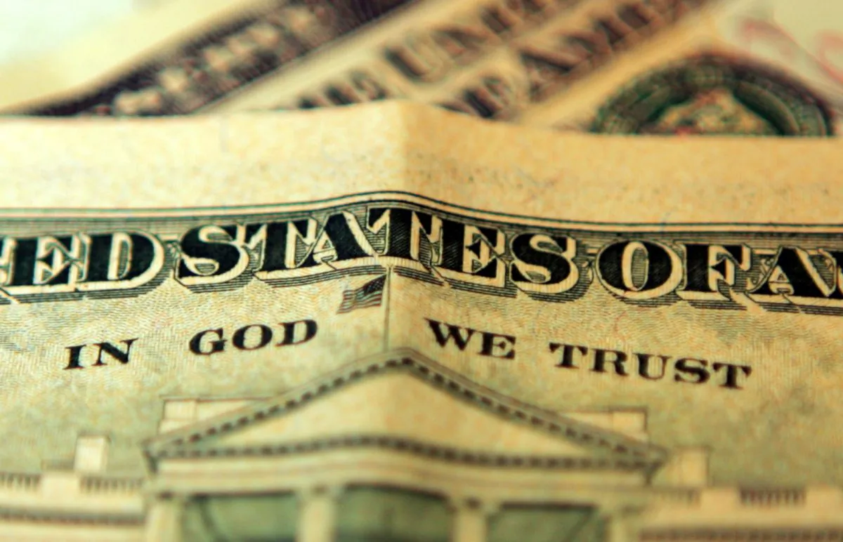 The phrase "In God We Trust" can be seen on an American ten dollar bill on Oct. 23, 2008. Hugh Pinney/Getty Images)