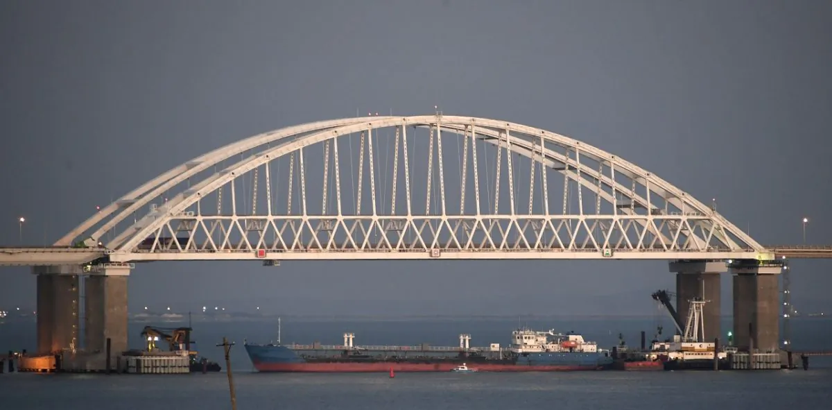 A Russian tanker under the the Kerch bridge blocks the passage to the Kerch Strait near Kerch, Crimea, on Nov. 25, 2018. (AP Photo)
