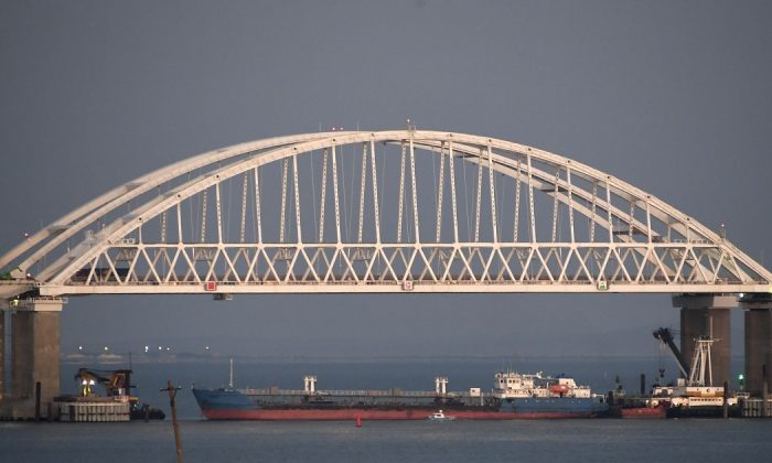 A Russian tanker under the the Kerch bridge blocks the passage to the Kerch Strait near Kerch, Crimea, on Nov. 25, 2018. (AP Photo)
